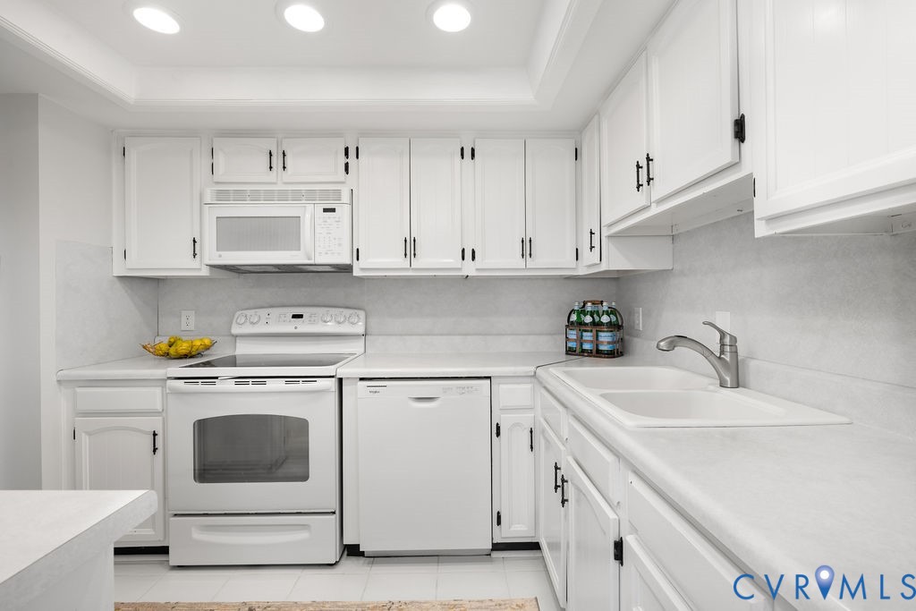 2956 Hathaway Road, Unit U704 Richmond, VA 23225 - Photo 4 of 42 Kitchen featuring white cabinetry with dark hardwa