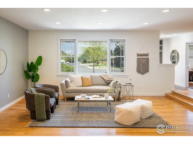 a living room with furniture potted plant and a window
