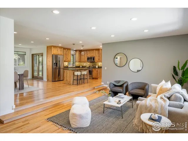 a living room with lots of furniture and view of kitchen