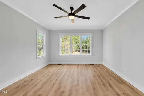 wooden floor in an empty room with a window