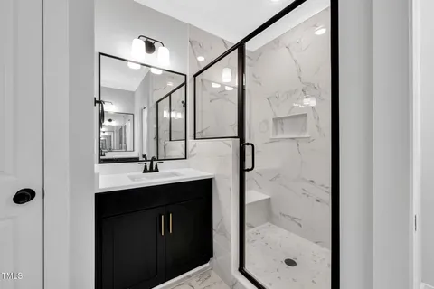 a bathroom with a shower sink and mirror