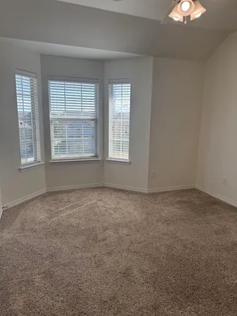 an empty room with a empty space and windows