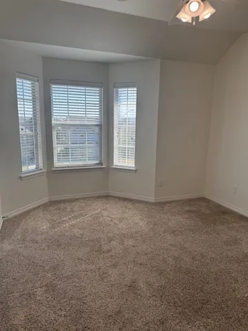 an empty room with a empty space and windows