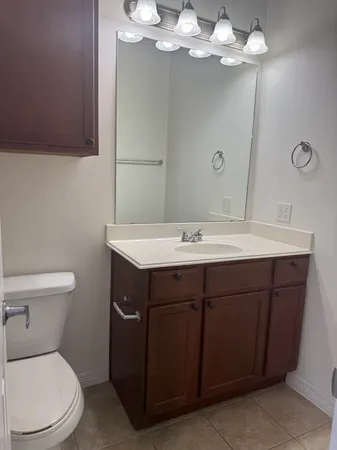 a bathroom with a sink vanity and toilet