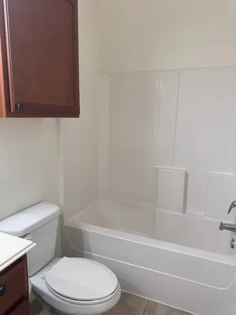a bathroom with a toilet and a bath tub