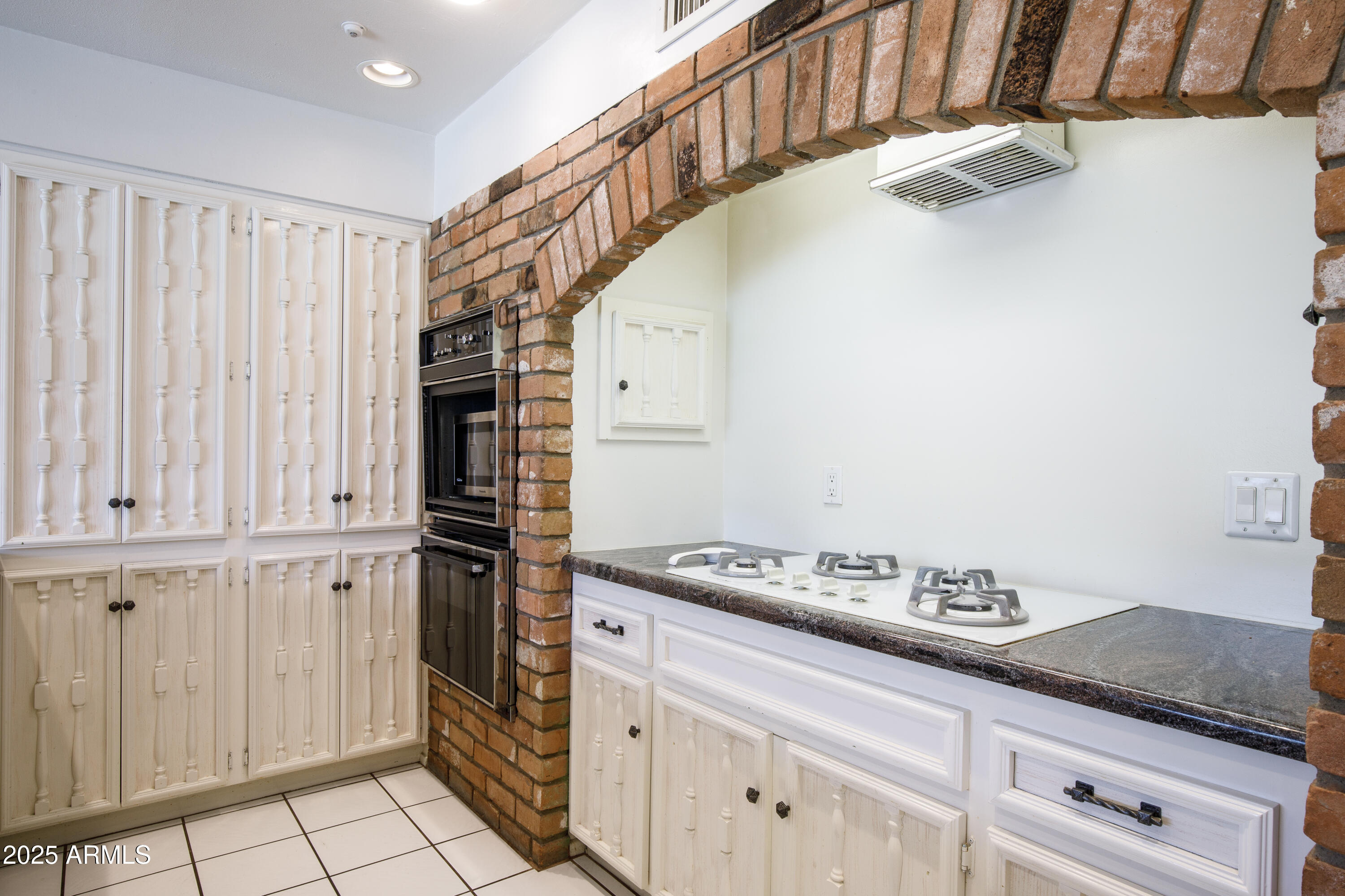 7125 North 2nd Place Phoenix, AZ 85020 - Photo 8 of 30 a kitchen with granite countertop a sink cabinets and stainless steel appliances