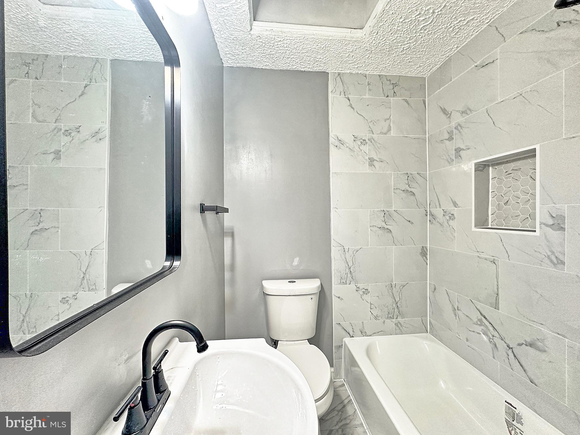 116 Hillvale Road Baltimore, MD 21229 - Photo 17 of 26 a bathroom with a bathtub and shower