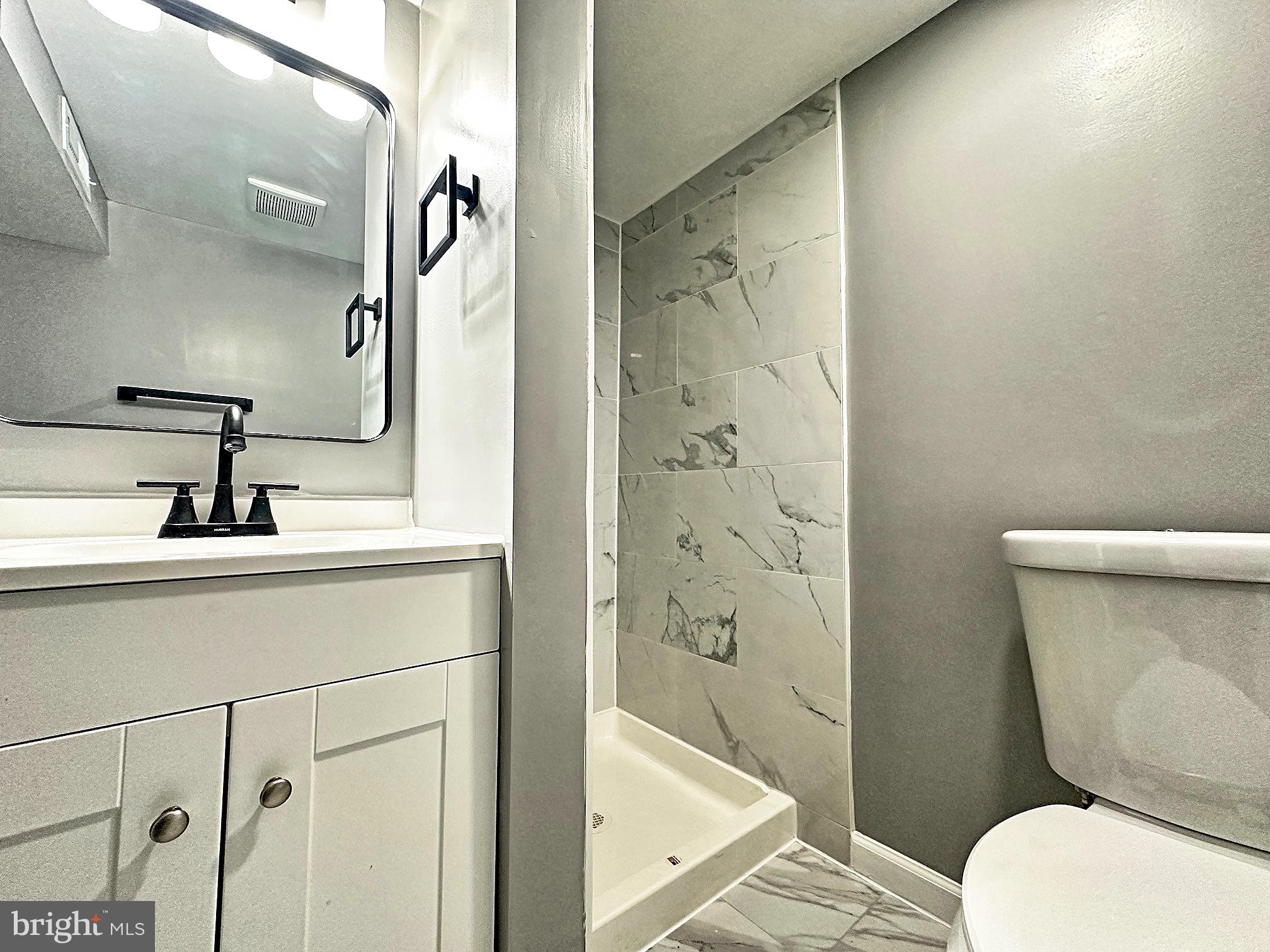 116 Hillvale Road Baltimore, MD 21229 - Photo 20 of 26 a bathroom with a sink a toilet a shower and a mirror