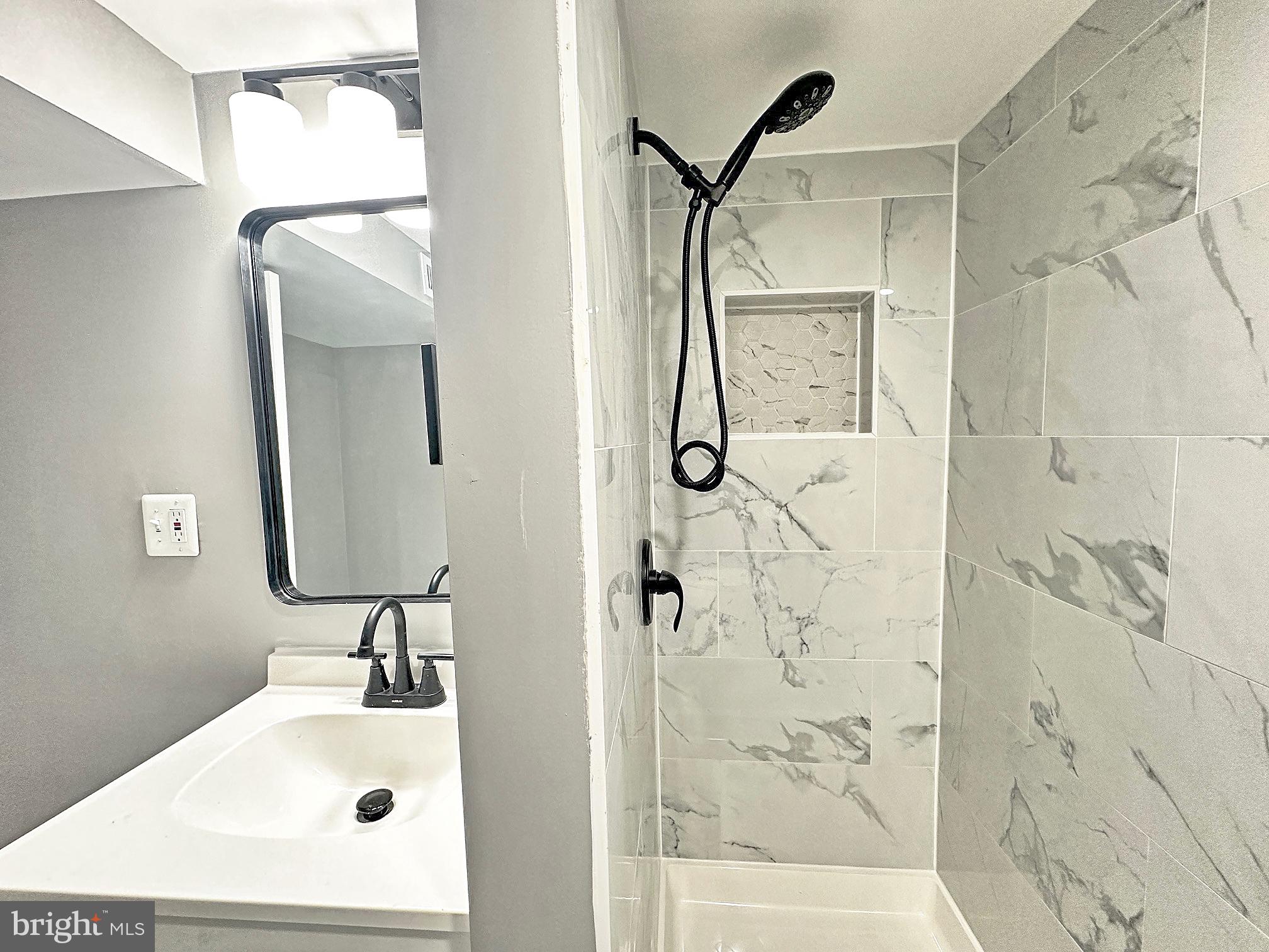 116 Hillvale Road Baltimore, MD 21229 - Photo 21 of 26 a bathroom with a sink mirror and shower