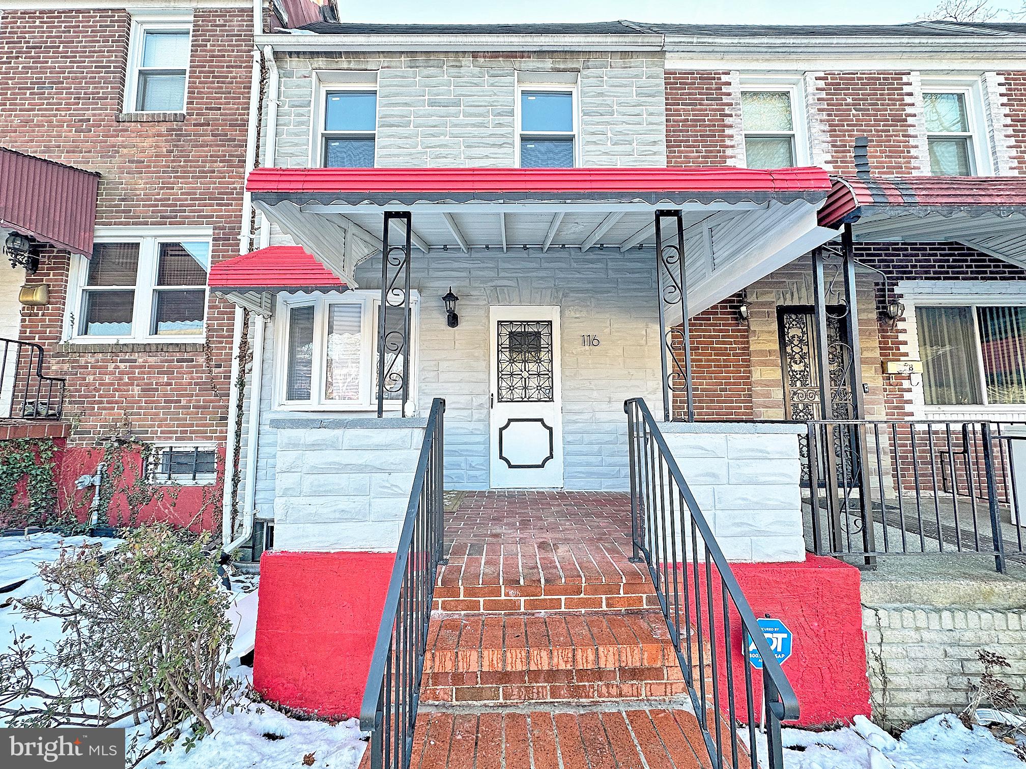 116 Hillvale Road Baltimore, MD 21229 - Photo 25 of 26 a front view of a building with red door