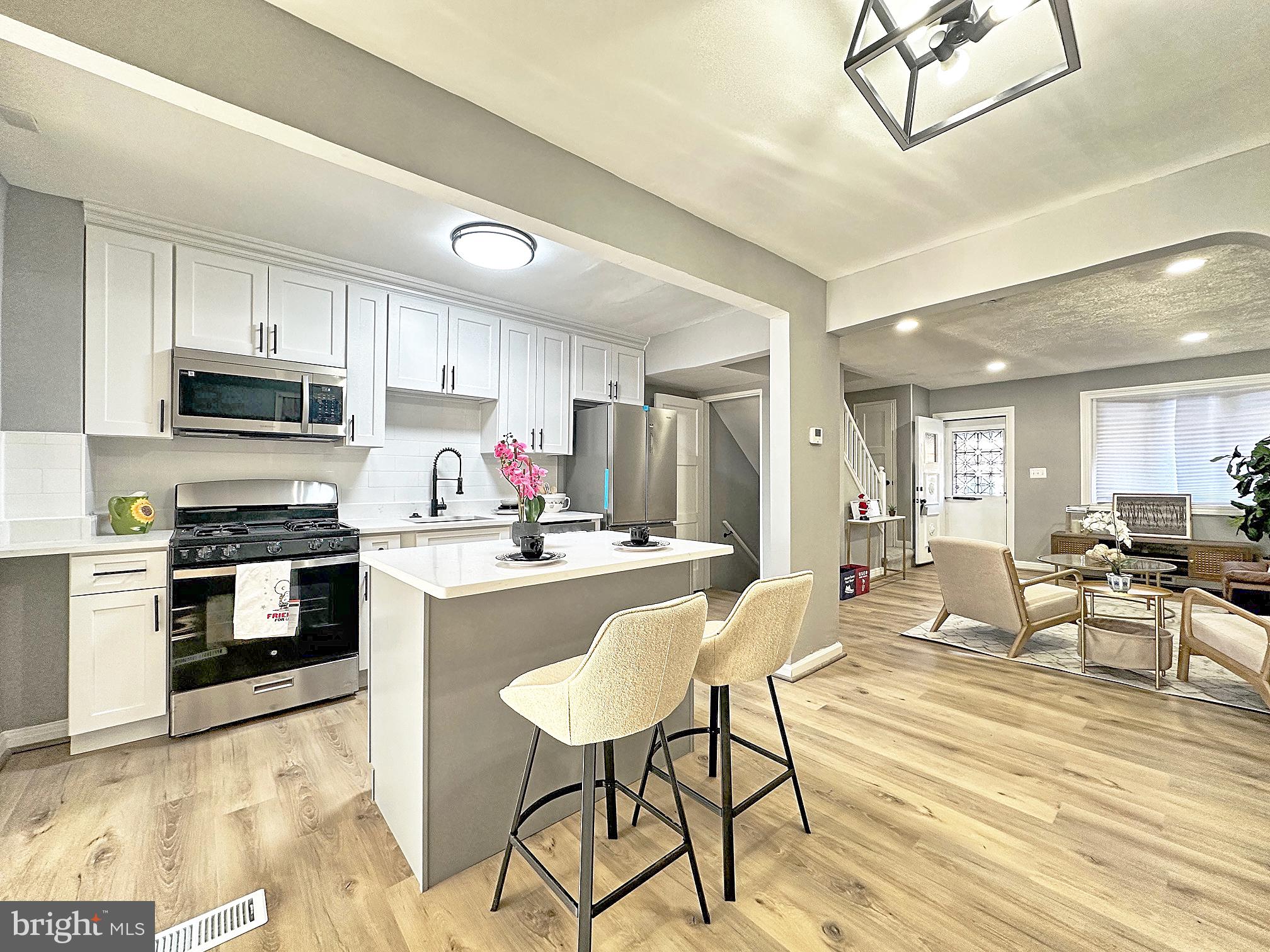 116 Hillvale Road Baltimore, MD 21229 - Photo 6 of 26 a large kitchen with cabinets appliances and a dining table