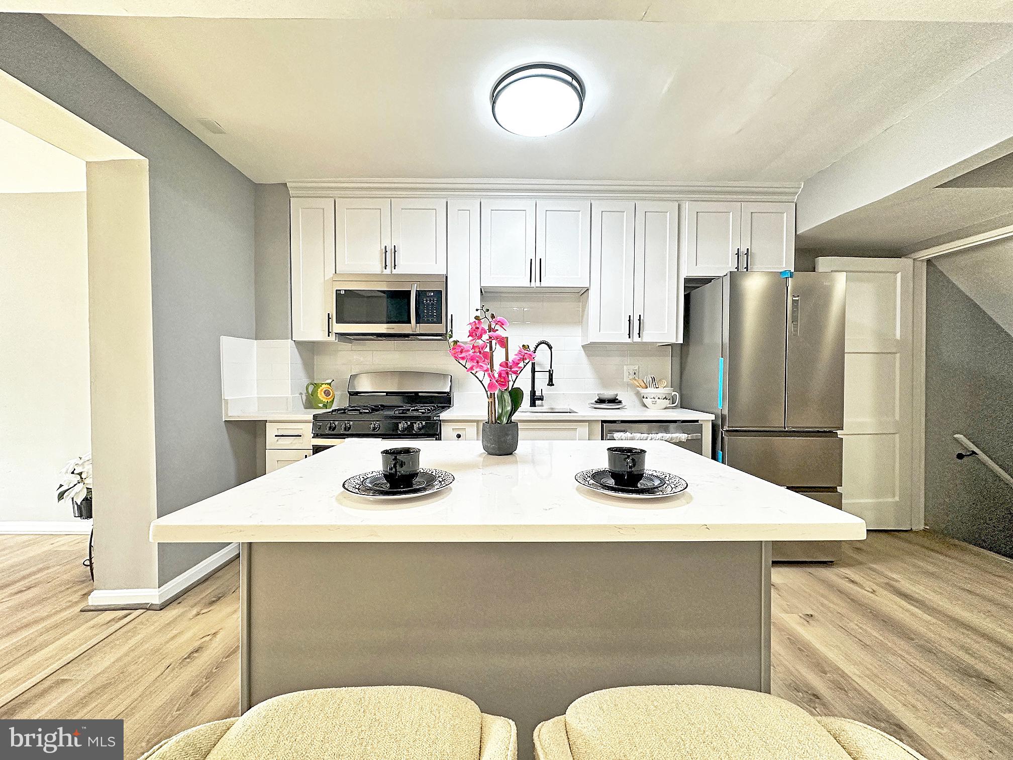 116 Hillvale Road Baltimore, MD 21229 - Photo 7 of 26 a kitchen with a refrigerator a stove a sink and a microwave