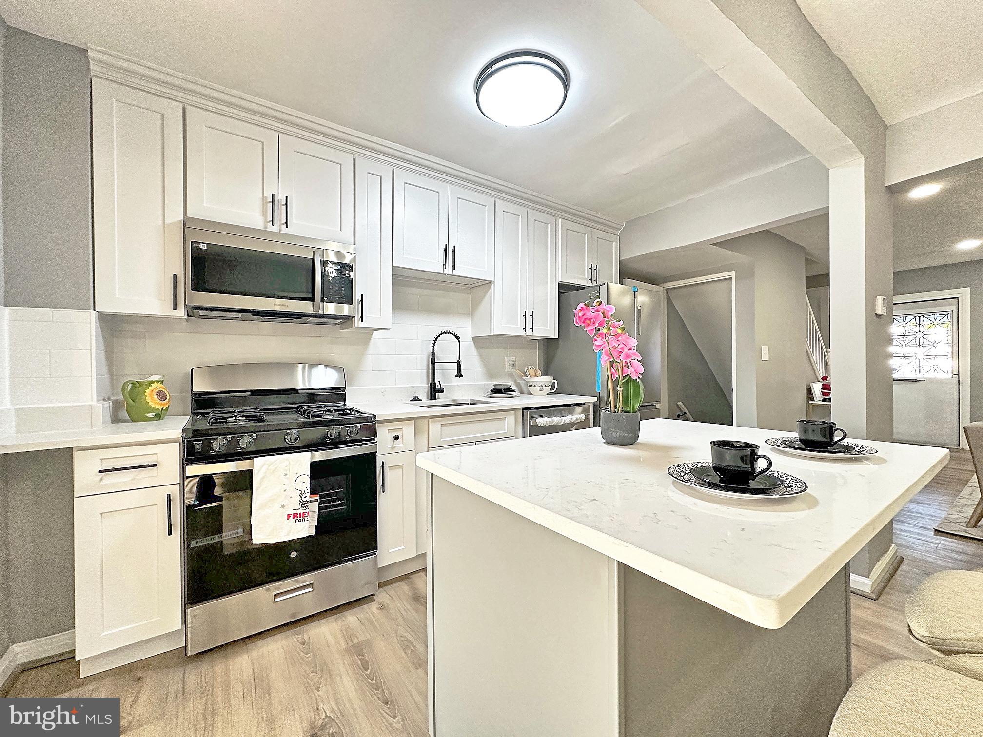 116 Hillvale Road Baltimore, MD 21229 - Photo 9 of 26 a kitchen with a stove a sink and a microwave