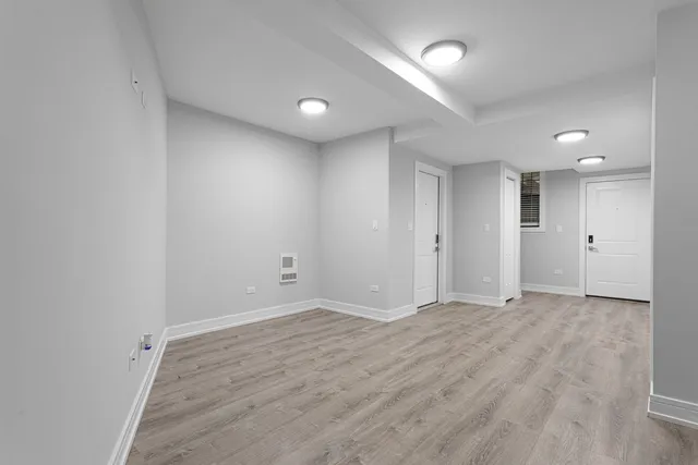 a view of a kitchen with a sink and refrigerator