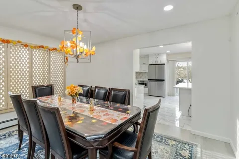 a view of a dining room with furniture wooden floor and chandelier