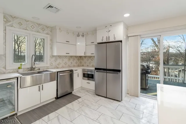 a kitchen with granite countertop a refrigerator and a sink