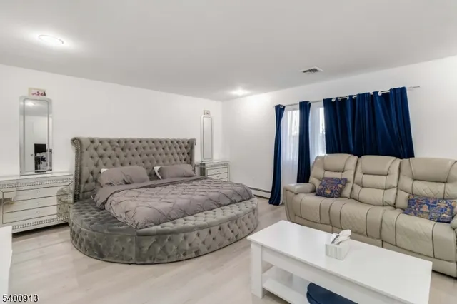 a bedroom with a bed and a couch