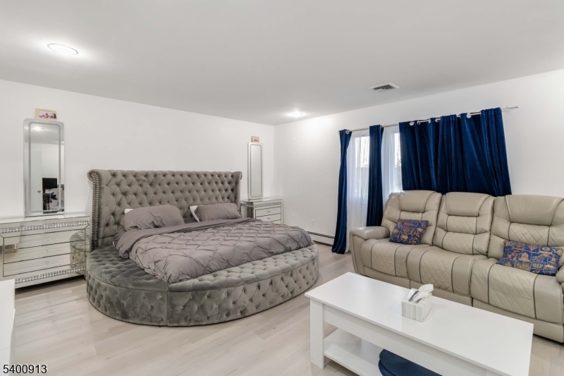 1 Wenonah Avenue Rockaway, NJ 07866 - Photo 17 of 34 a bedroom with a bed and a couch