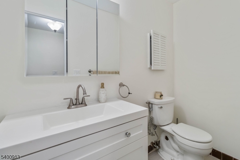 1 Wenonah Avenue Rockaway, NJ 07866 - Photo 27 of 34 a bathroom with a sink a toilet and a mirror