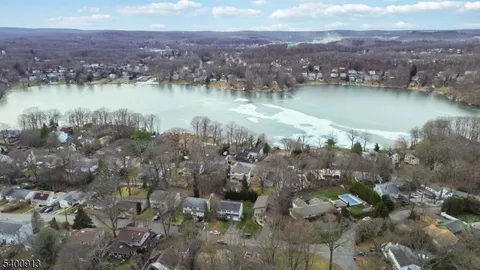 an aerial view of a houses with a lake