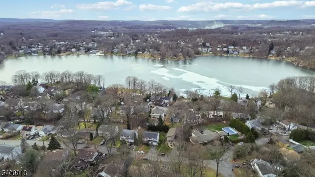 an aerial view of a houses with a lake