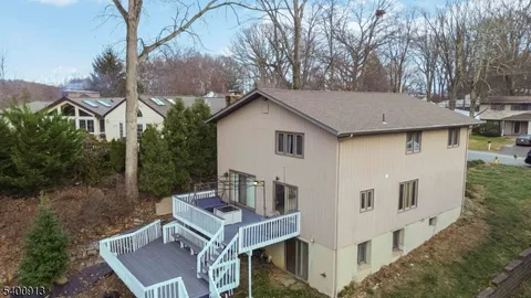 a white house covered with tall trees