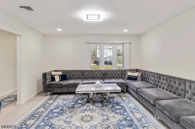 a living room with furniture and a rug