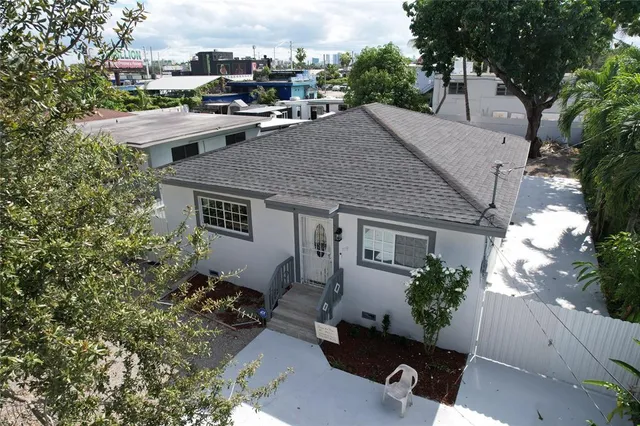 a aerial view of a house with swimming pool and sitting area