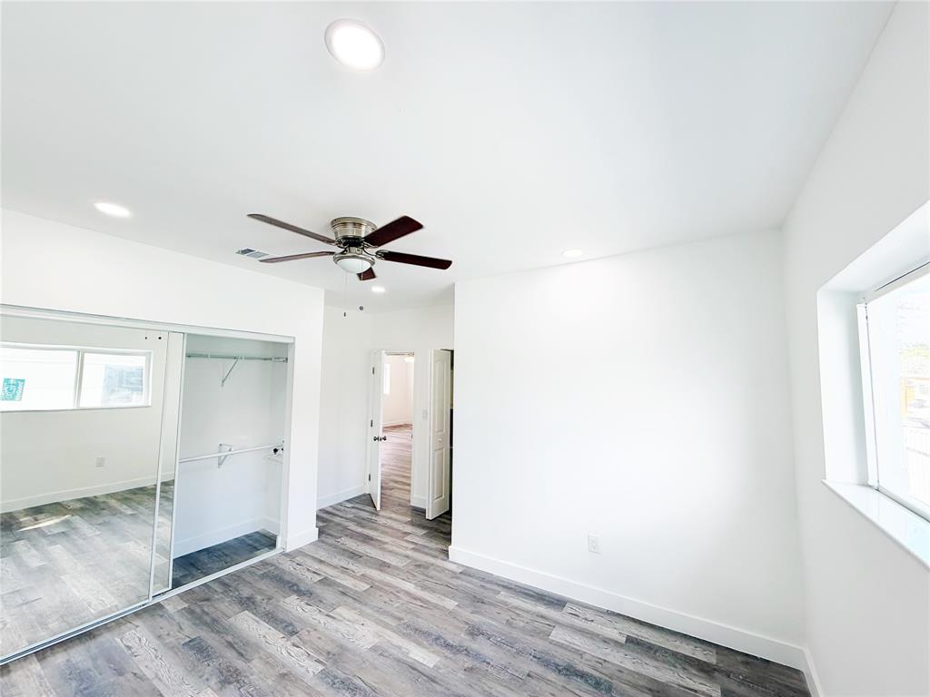 778 Northwest 80th Street Miami, FL 33150 - Photo 12 of 35 an empty room with wooden floor and windows