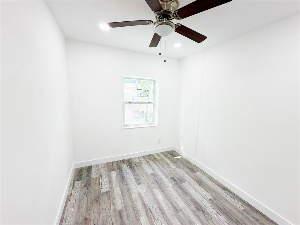 778 Northwest 80th Street Miami, FL 33150 - Photo 18 of 35 an empty room with a window and a ceiling fan
