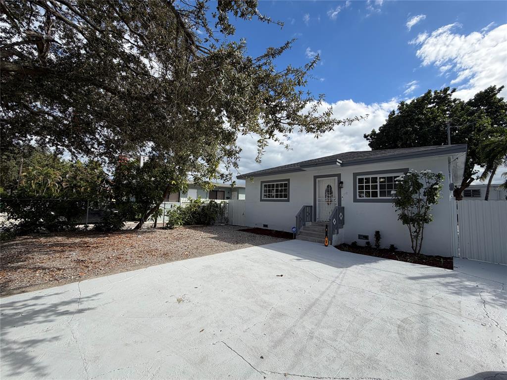 778 Northwest 80th Street Miami, FL 33150 - Photo 2 of 35 a view of a house with a tree in front of it