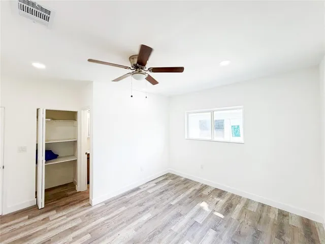 a view of a livingroom with a ceiling fan and wooden floor