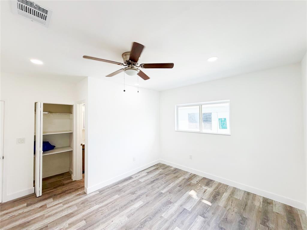 778 Northwest 80th Street Miami, FL 33150 - Photo 22 of 35 a view of a livingroom with a ceiling fan and wooden floor