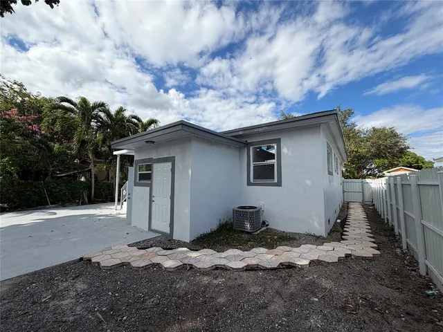 a view of a wooden door and a window