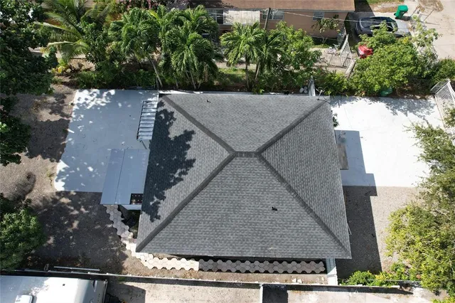 an aerial view of a house with a yard