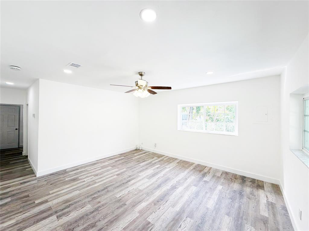 778 Northwest 80th Street Miami, FL 33150 - Photo 8 of 35 an empty room with wooden floor and windows
