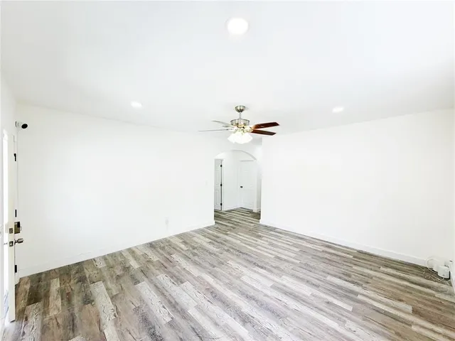 a view of empty room with wooden floor