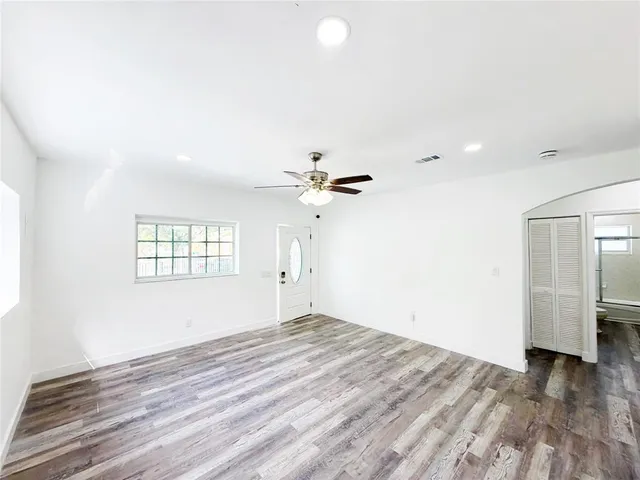 wooden floor in an empty room with a window