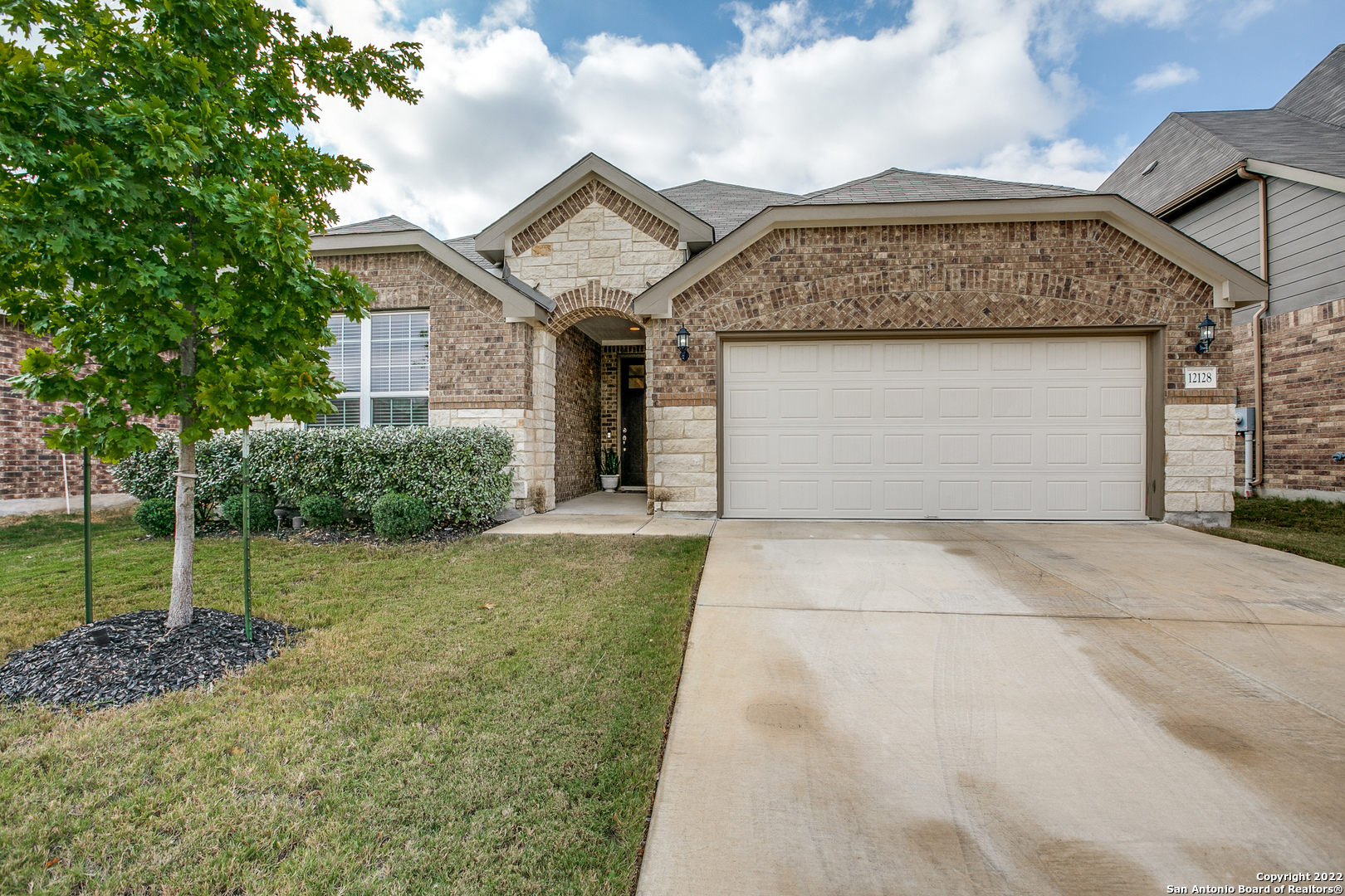12128 Coyote Ranch San Antonio, TX 78254 - Photo 1 of 1 a front view of a house with a yard and garage