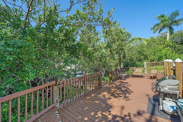 a pathway of a house with a yard and large trees