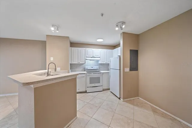 a kitchen with a sink stove and refrigerator