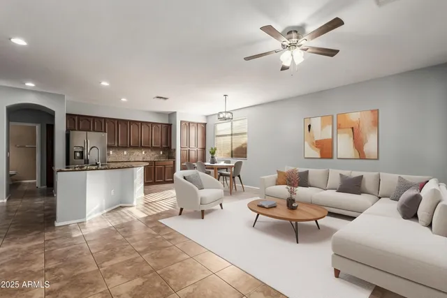 a living room with furniture and kitchen view