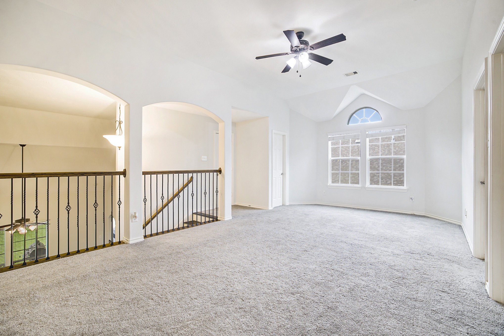 20692 Oakhurst Meadows Drive Porter, TX 77365 - Photo 20 of 37 an empty room with chandelier fan and windows