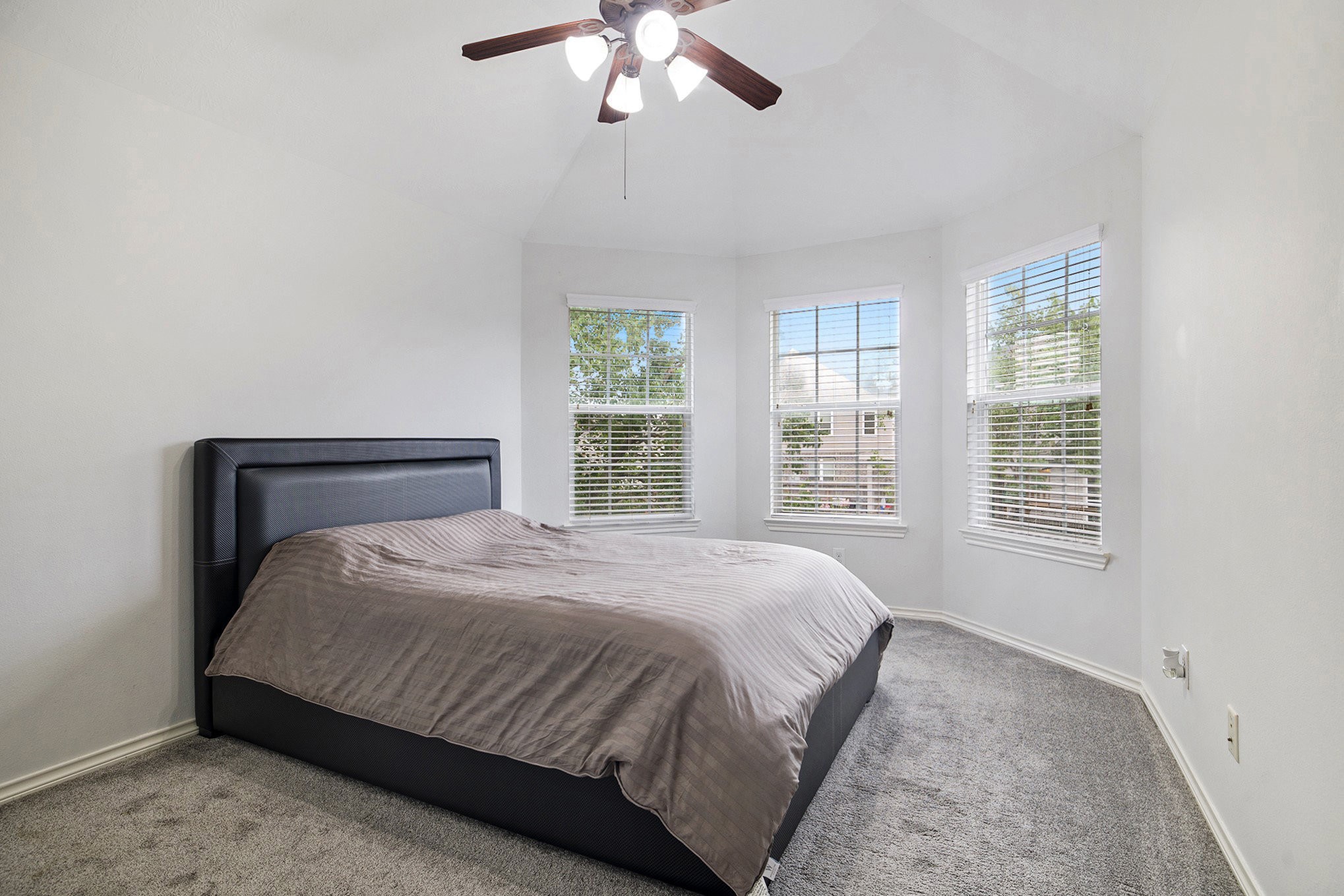 20692 Oakhurst Meadows Drive Porter, TX 77365 - Photo 27 of 37 a bedroom with a large bed and a chandelier