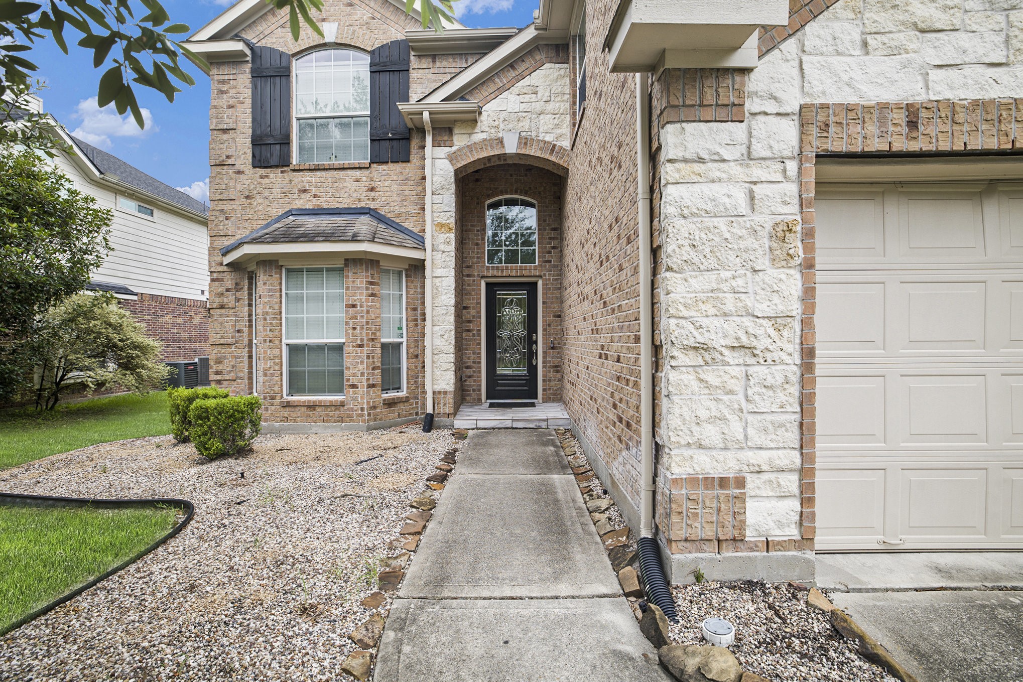 20692 Oakhurst Meadows Drive Porter, TX 77365 - Photo 3 of 37 a front view of a house with garden