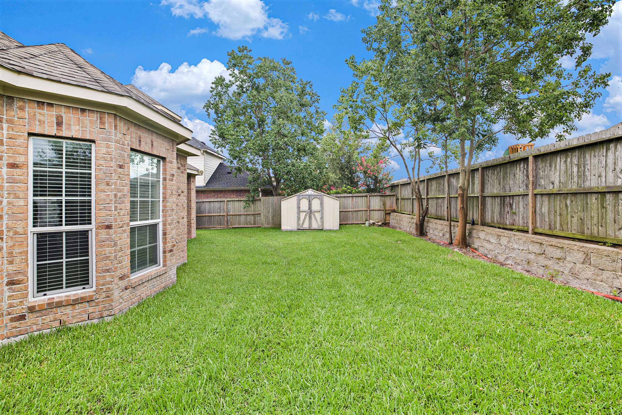 20692 Oakhurst Meadows Drive Porter, TX 77365 - Photo 35 of 37 a view of a house with a back yard