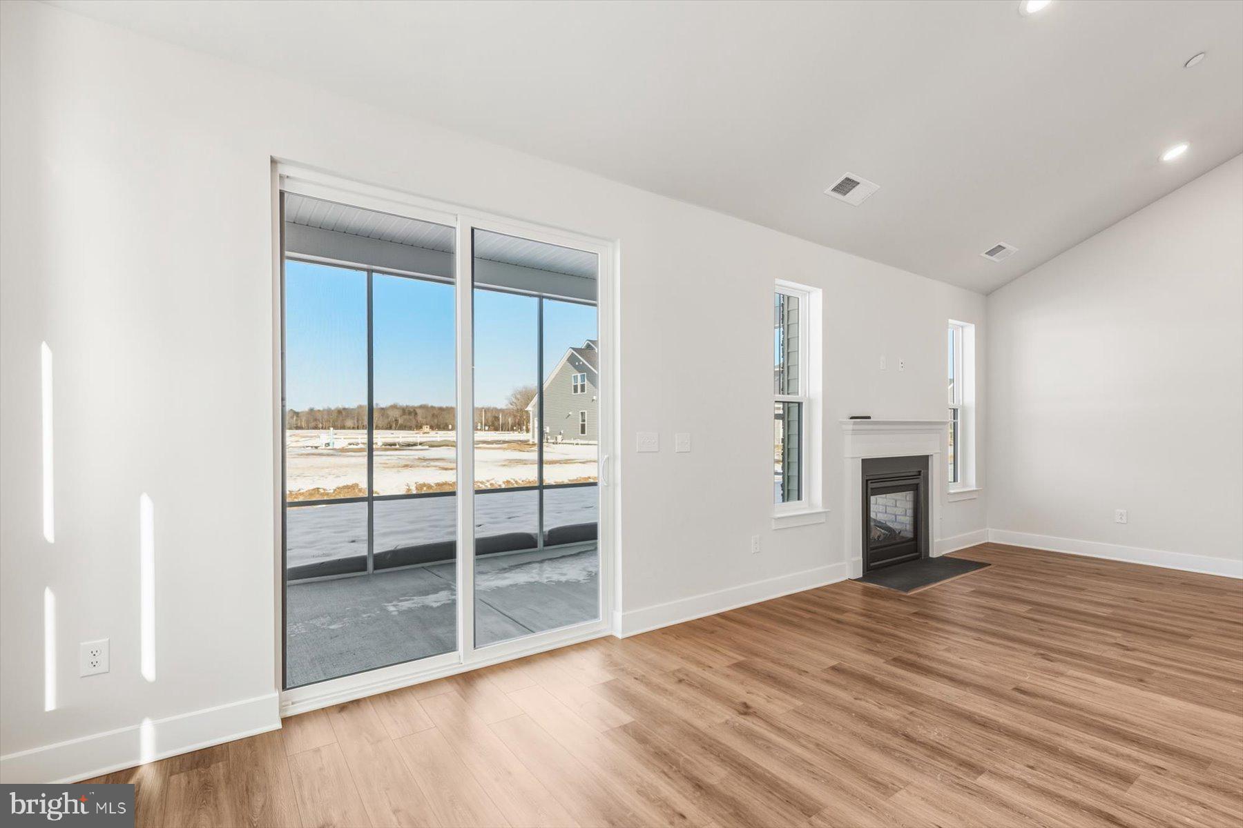 104 Sunbeam Way Milton, DE 19968 - Photo 15 of 56 a view of empty room with wooden floor and fireplace