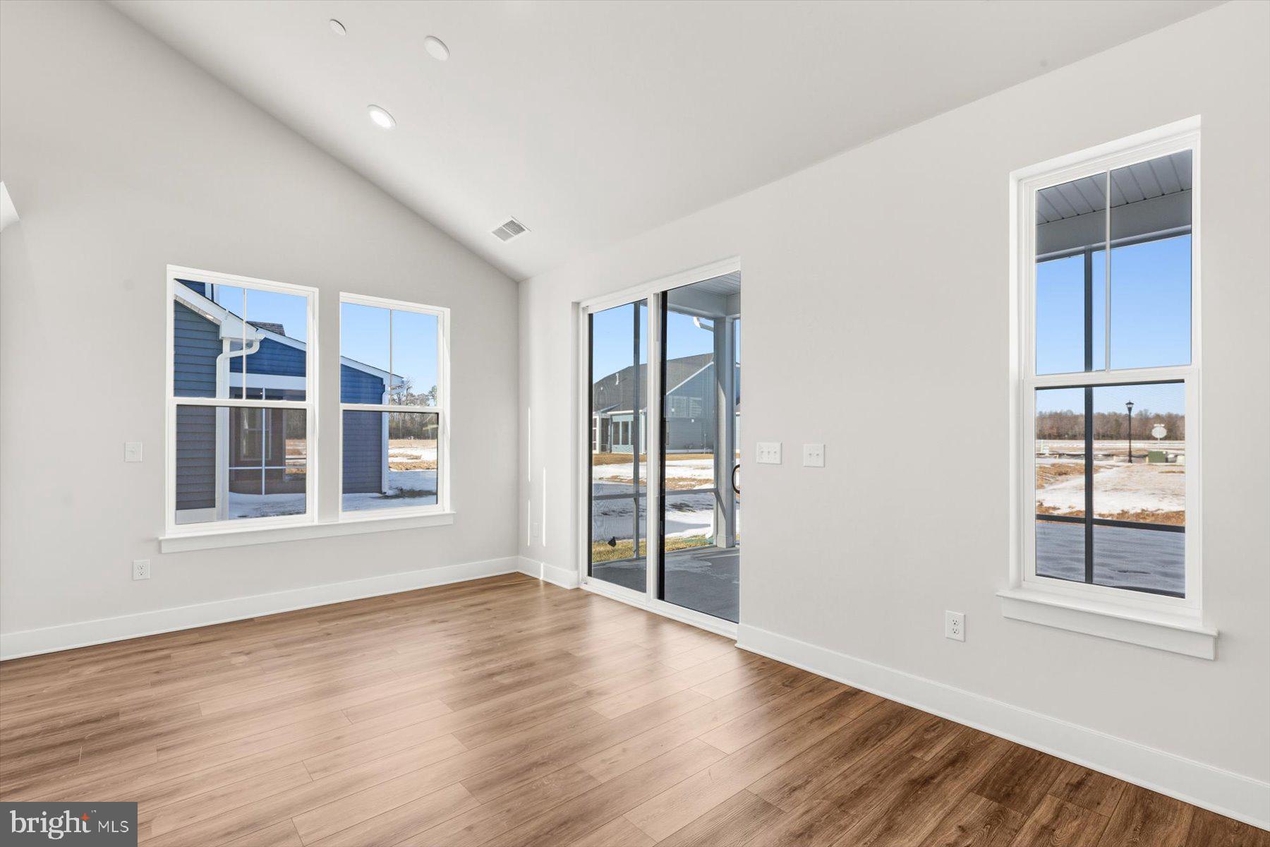 104 Sunbeam Way Milton, DE 19968 - Photo 16 of 56 an empty room with wooden floor and windows