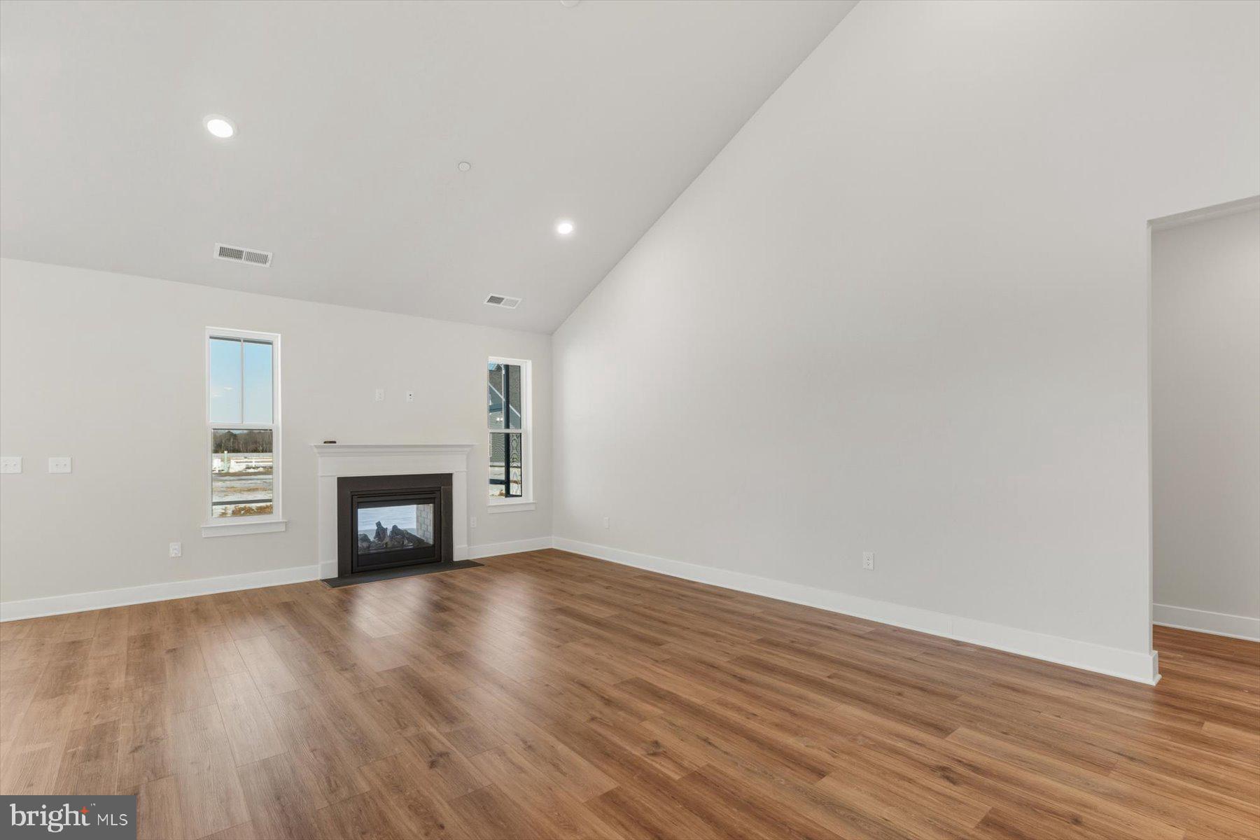 104 Sunbeam Way Milton, DE 19968 - Photo 21 of 56 a view of an empty room with wooden floor fireplace and a window