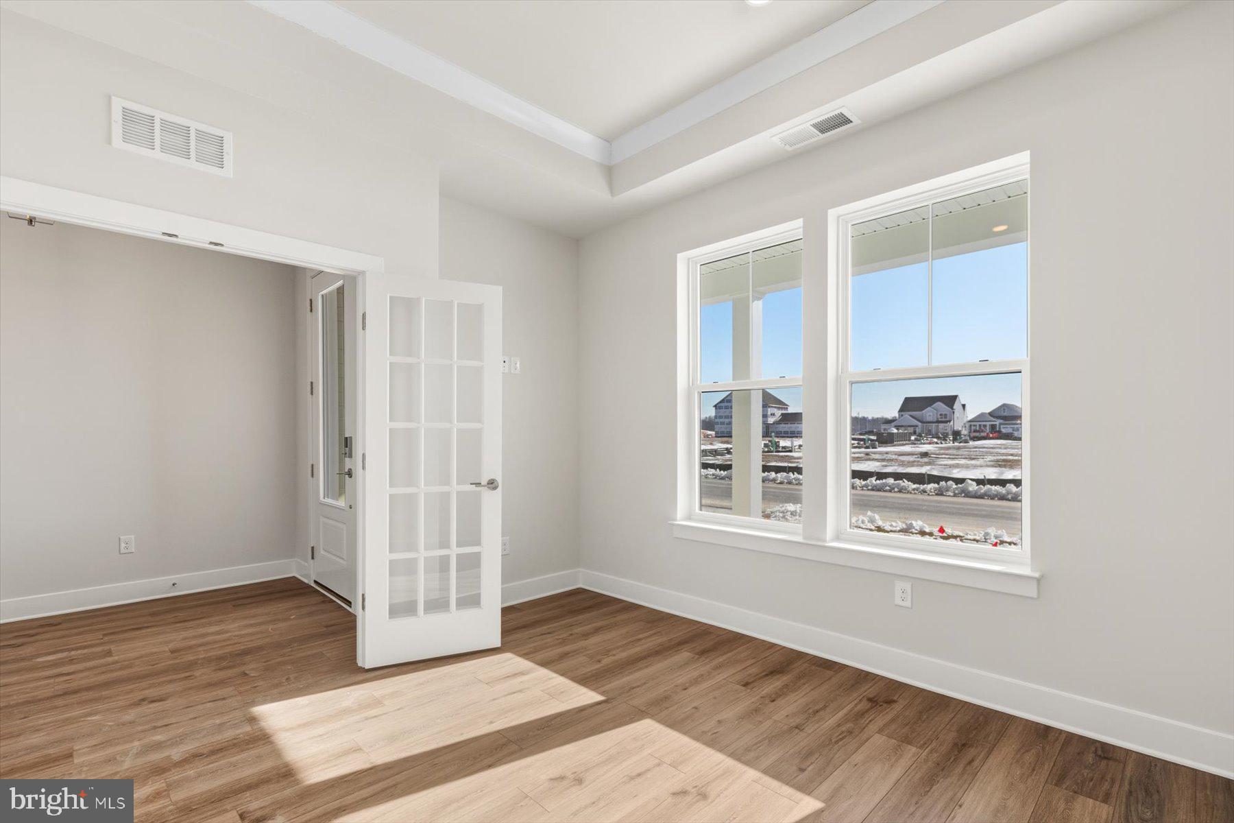 104 Sunbeam Way Milton, DE 19968 - Photo 25 of 56 a view of an empty room with wooden floor and a window